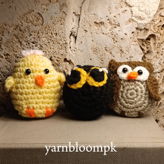 Handmade crochet duck, owl and black cat keychain bundle displayed on a soft neutral background by Yarnbloompk